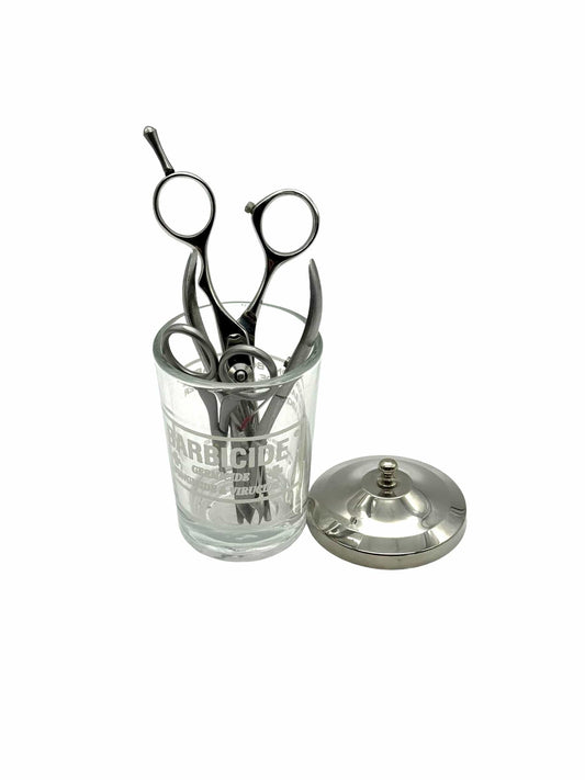 Barbicide disinfecting jar with sanitized shears, the EPA-registered standard for salon tool disinfection