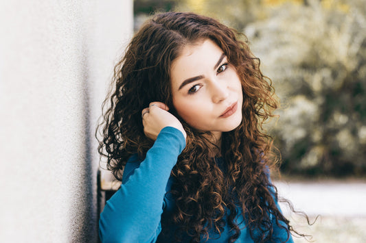 Dimensional, richly toned curly hair, the kind of result a color-depositing conditioner helps maintain