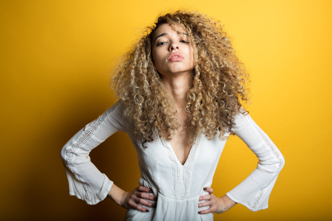 Stylist-focused editorial portrait illustrating healthy scalp and hair care, used for a dandruff vs dry scalp guide